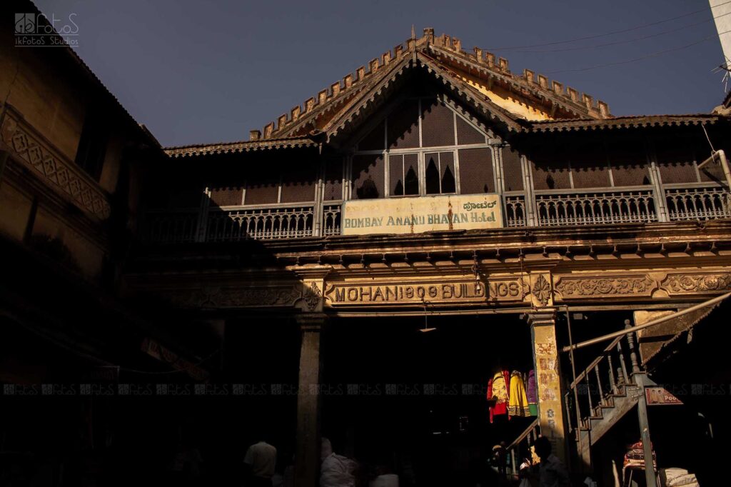 In the heart of Chickpet, Bangalore Karnataka where the old world brushes against the new, stands the Mohan Buildings, a grand relic from 1909. Built by the visionary Hajee Ismail Sait.